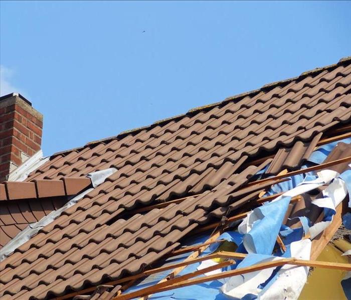 storm damage to roof, brown tiles, roof damage